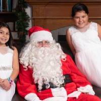 Two little girls with Santa.